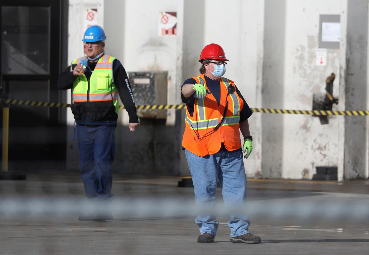 ‘Elbow to elbow:’ North America meat plant workers fall ill, walk off jobs