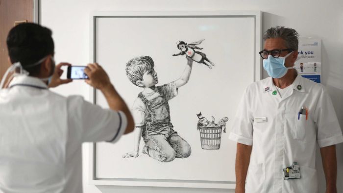 Banksy artwork depicting frontline NHS staff as heroes adorns British hospital