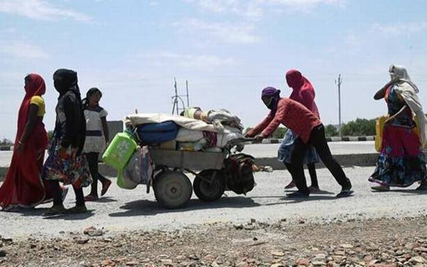 Weary migrant workers carry crashed hopes en path their homes