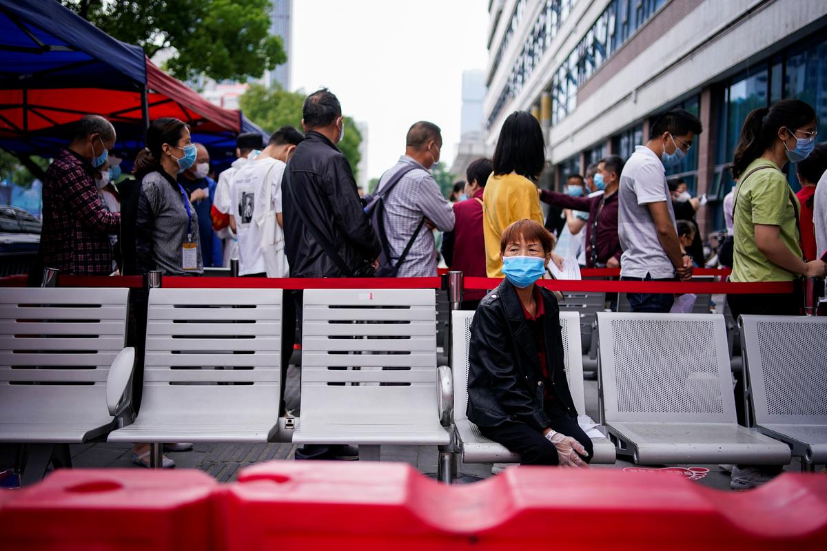 Crowds at Wuhan clinics fear coronavirus testing could rekindle disease