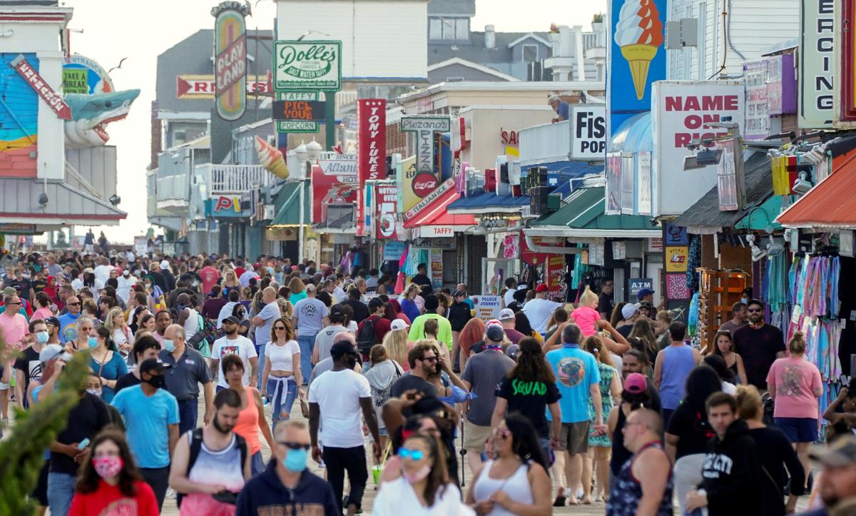 Americans spend holiday at beaches and parks as virus death toll nears 100,000