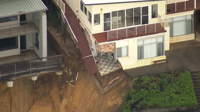 Structures partially collapse after another night of raving seas on the NSW Central Coast