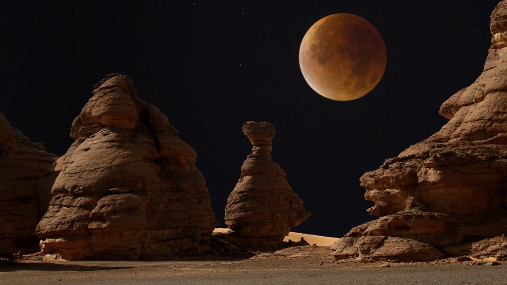 Why does the moon turn crimson at some level of a complete lunar eclipse?