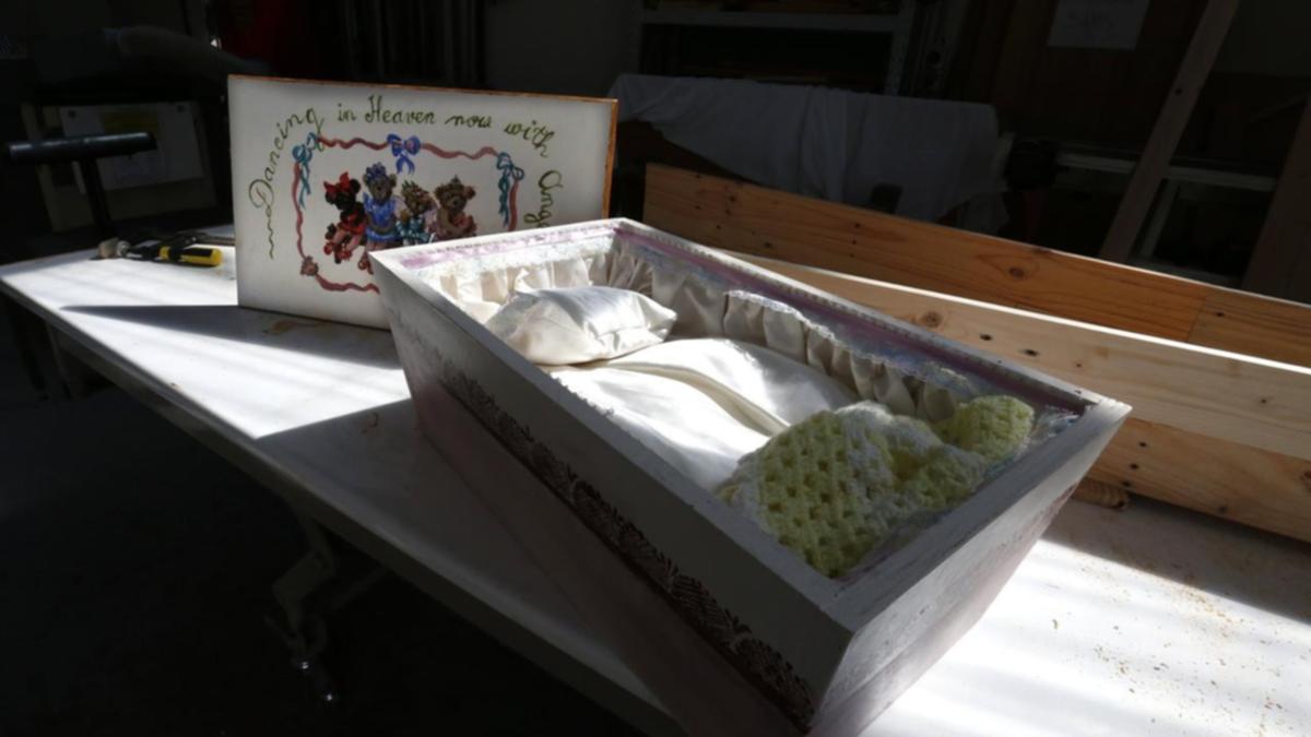 Coffins and garments for grieving dad and mom