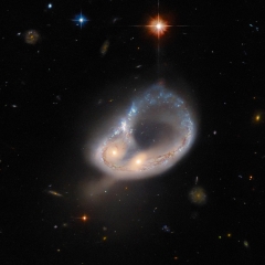 Hubble Hunts an Unusual Galaxy– Distorted by Gravity and Twisted Into a Colossal Ring