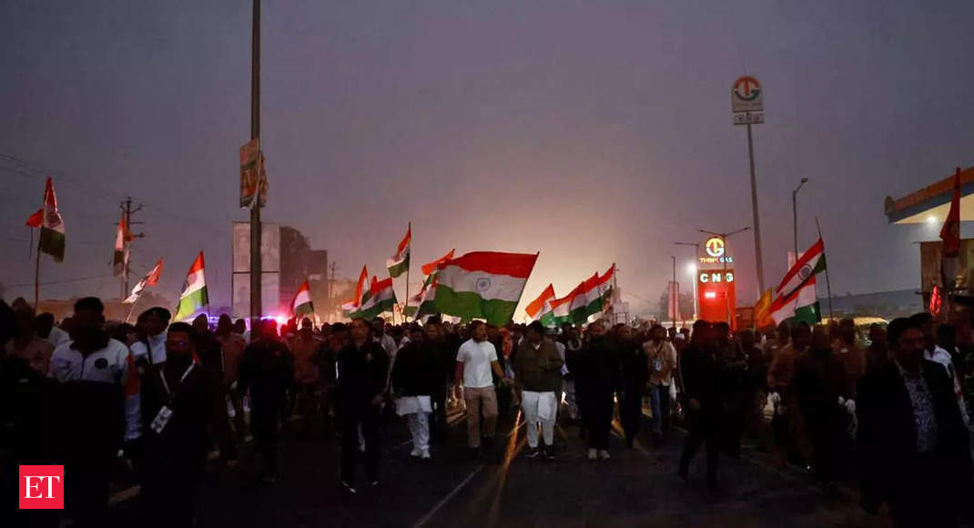 Congress warms to tee shirt concept: Party employees from Amethi in white tees march along with Rahul Gandhi