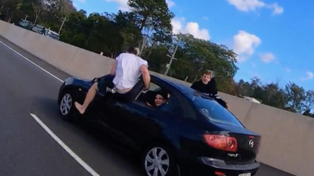 Wannabe stuntman attempts air-walking out of moving vehicle on Aussie highway