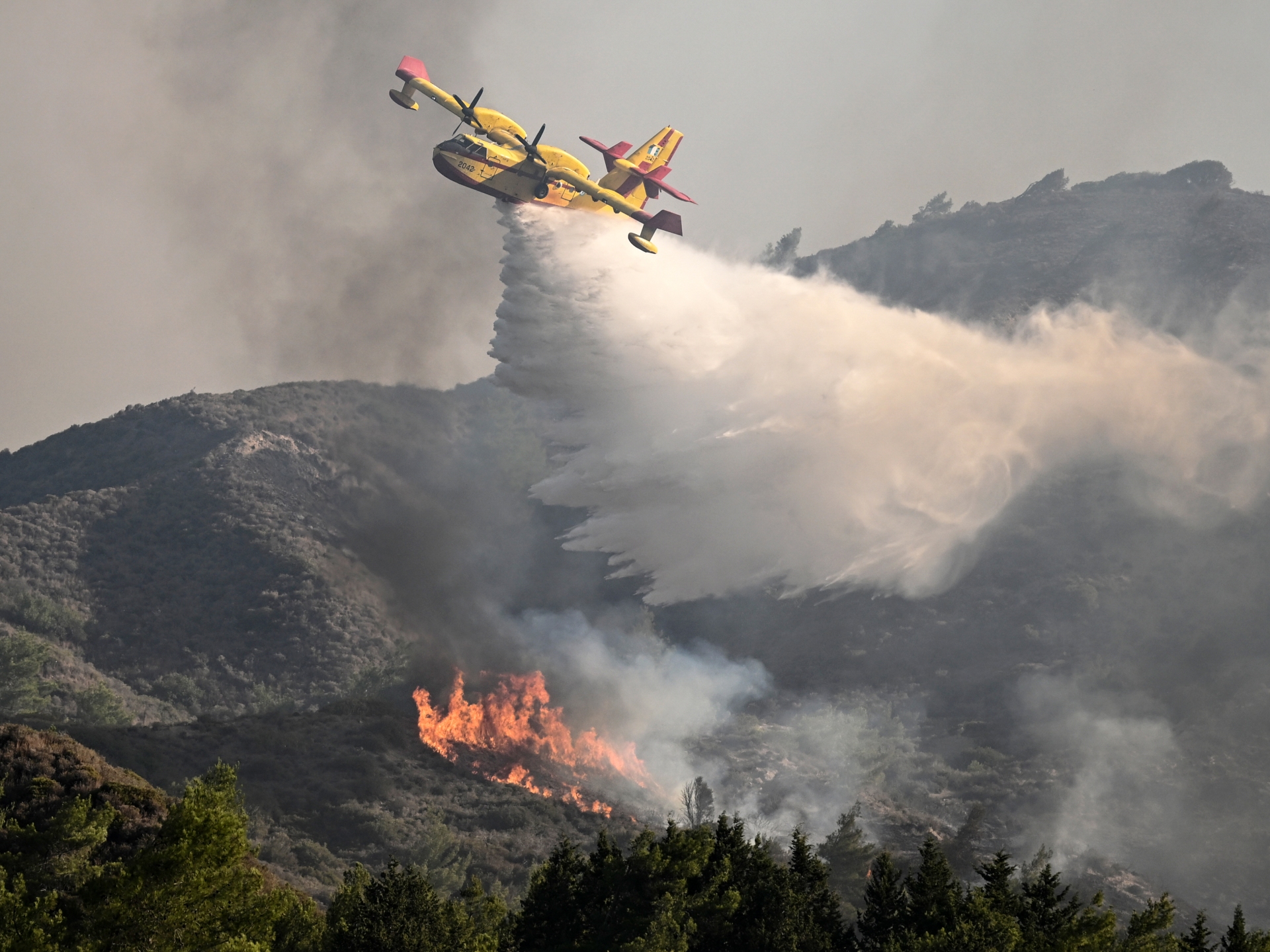 Firefighting airplane crashes in Greece as wildfires rage