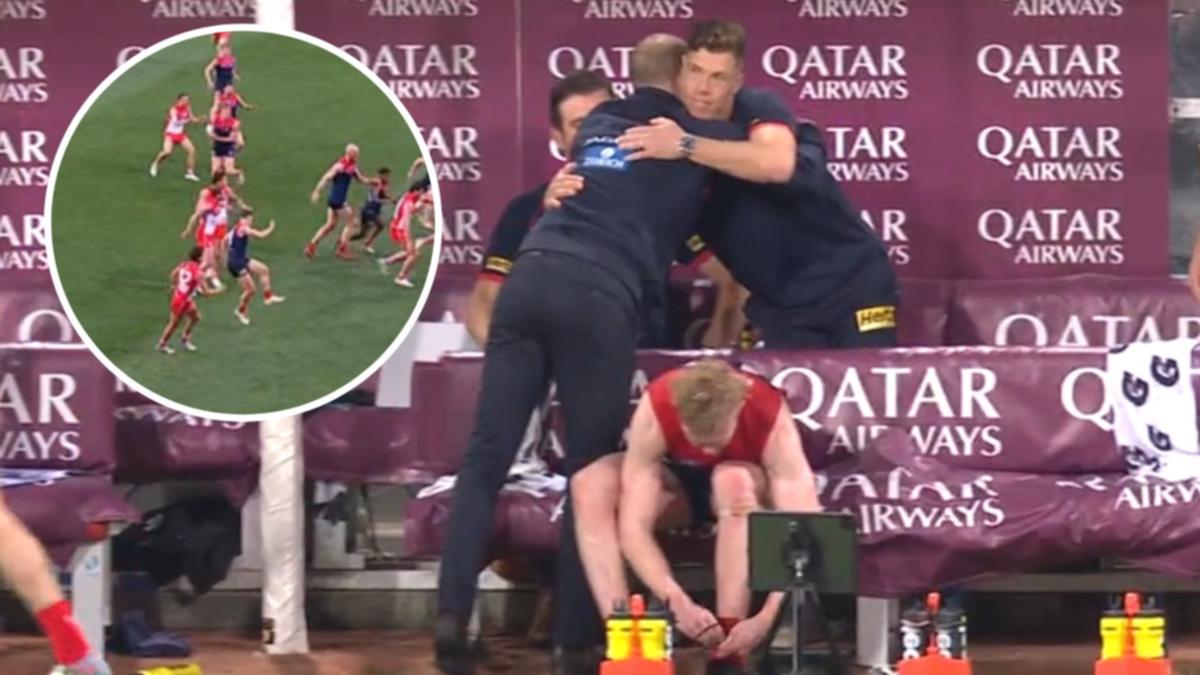 Simon Goodwin consoles Jake Melksham after Melbourne veteran hurts knee in AFL clash with Sydney