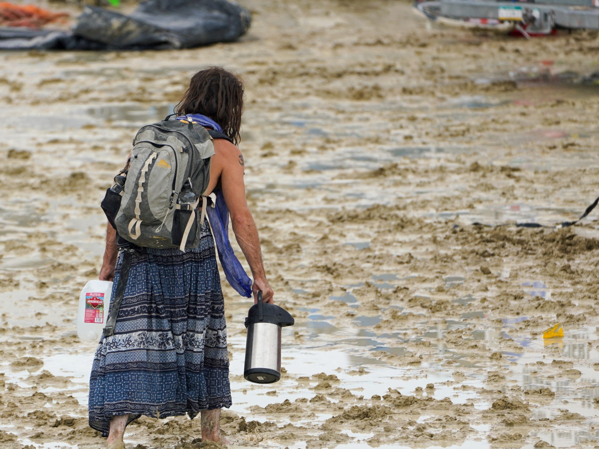 Death at Burning Man examined in United States, thousands stranded by flooding