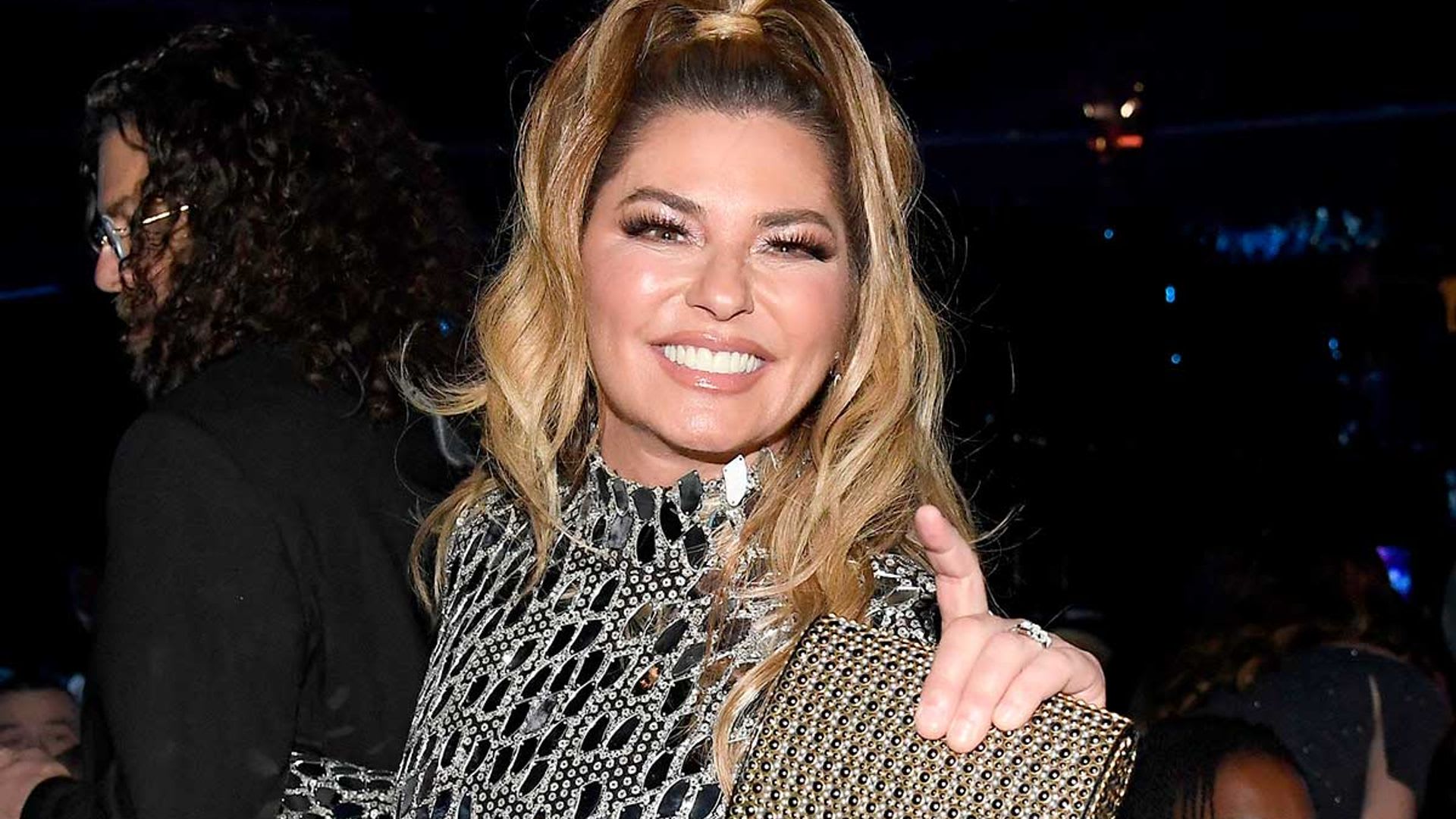 Shania Twain is a bombshell in large bodysuit and outrageous feathered boots