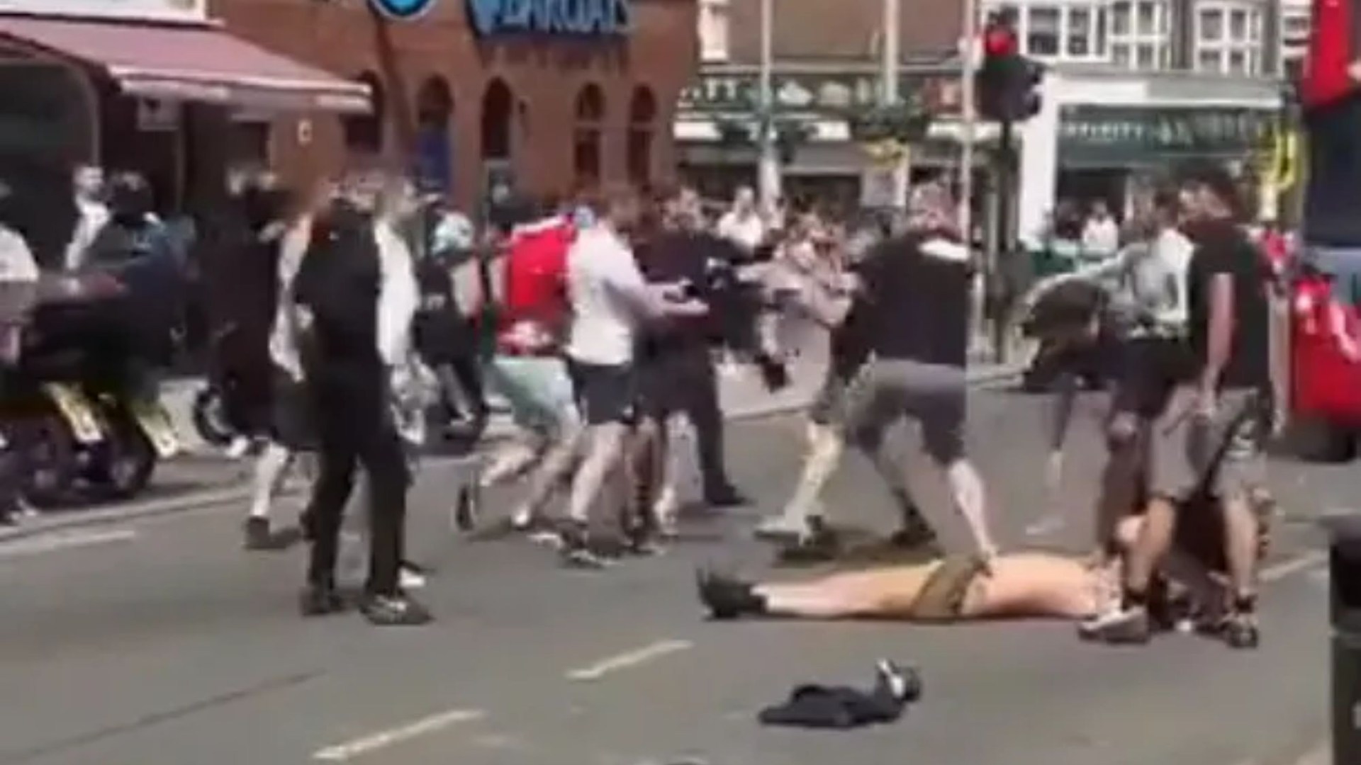 Stunning minute Man Utd and City fans brawl in the street before FA Cup last– leaving shirtless male knocked out cold