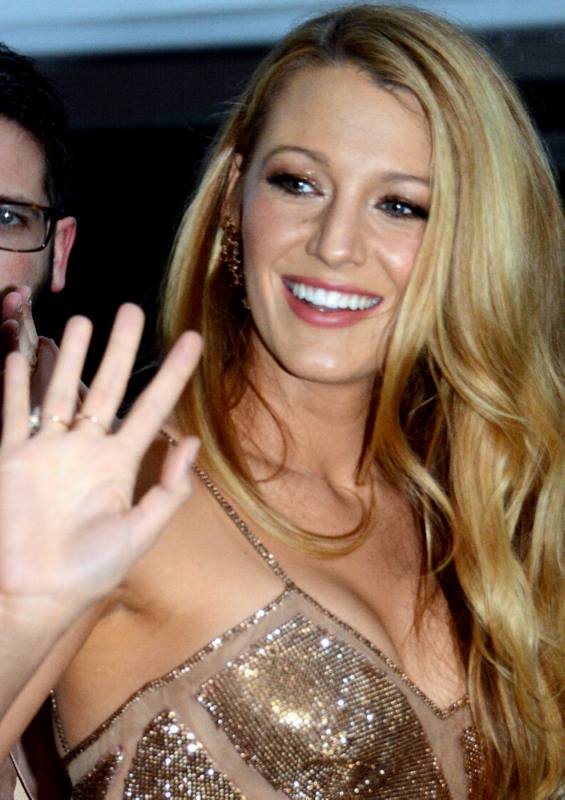 Blake Lively is a bronzed goddess in glimmering jeans mini gown and high-rise building heels