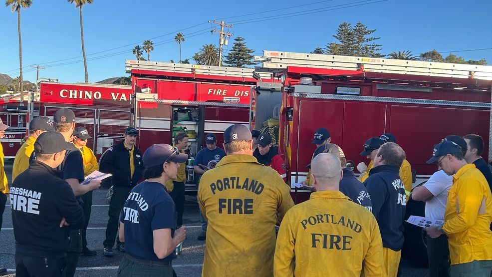 Firefighters battle to contain Los Angeles wildfires as winds forecast to return