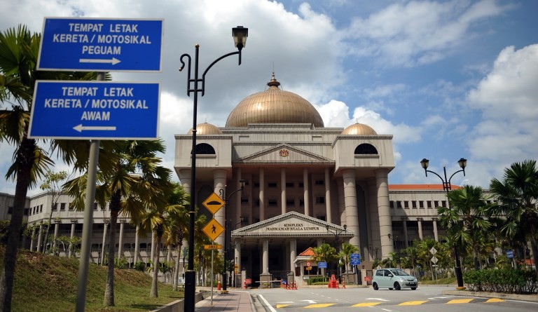 Islamic court in Indonesia sentences two men to public caning after they were caught hugging and kissing